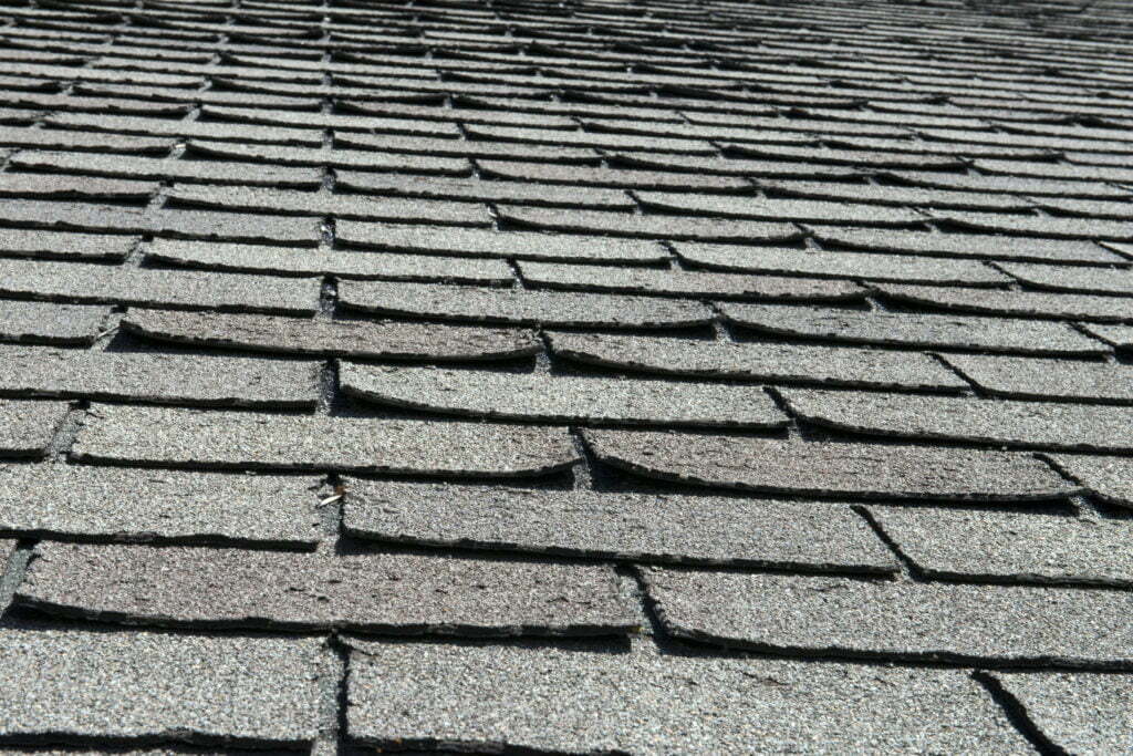 Curled and lifted shingles from storm damage
